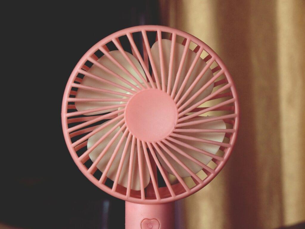 Pink handheld fan with unique design